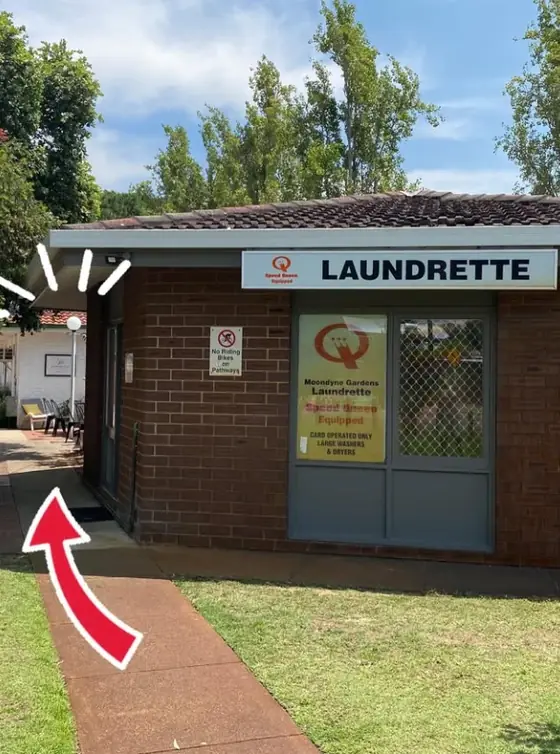 Footpath leading past the side of the brick Moondyne Gardens Laundrette